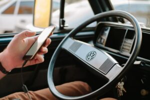 Utilisation du téléphone portable en voiture. Un utilisateur d'une voiture conventionnelle utilise son portable lors de la conduite.