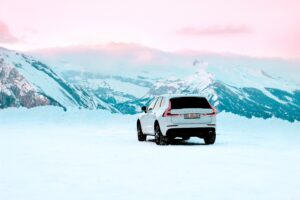 Peut-on mettre des pneus été en hiver ? Une voiture sur la neige à la montagne